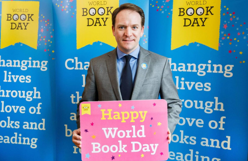Gareth Davies MP holding a sign in support of World Book Day