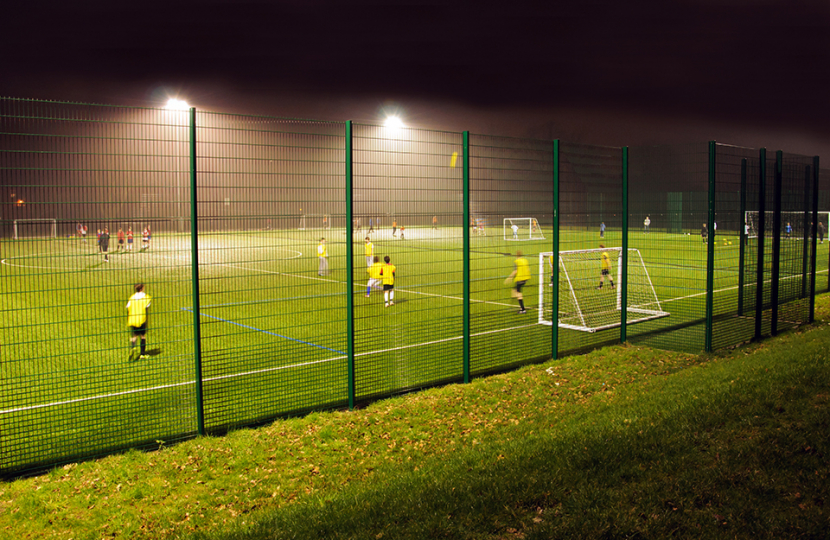 Football pitch with goalposts and floodlights